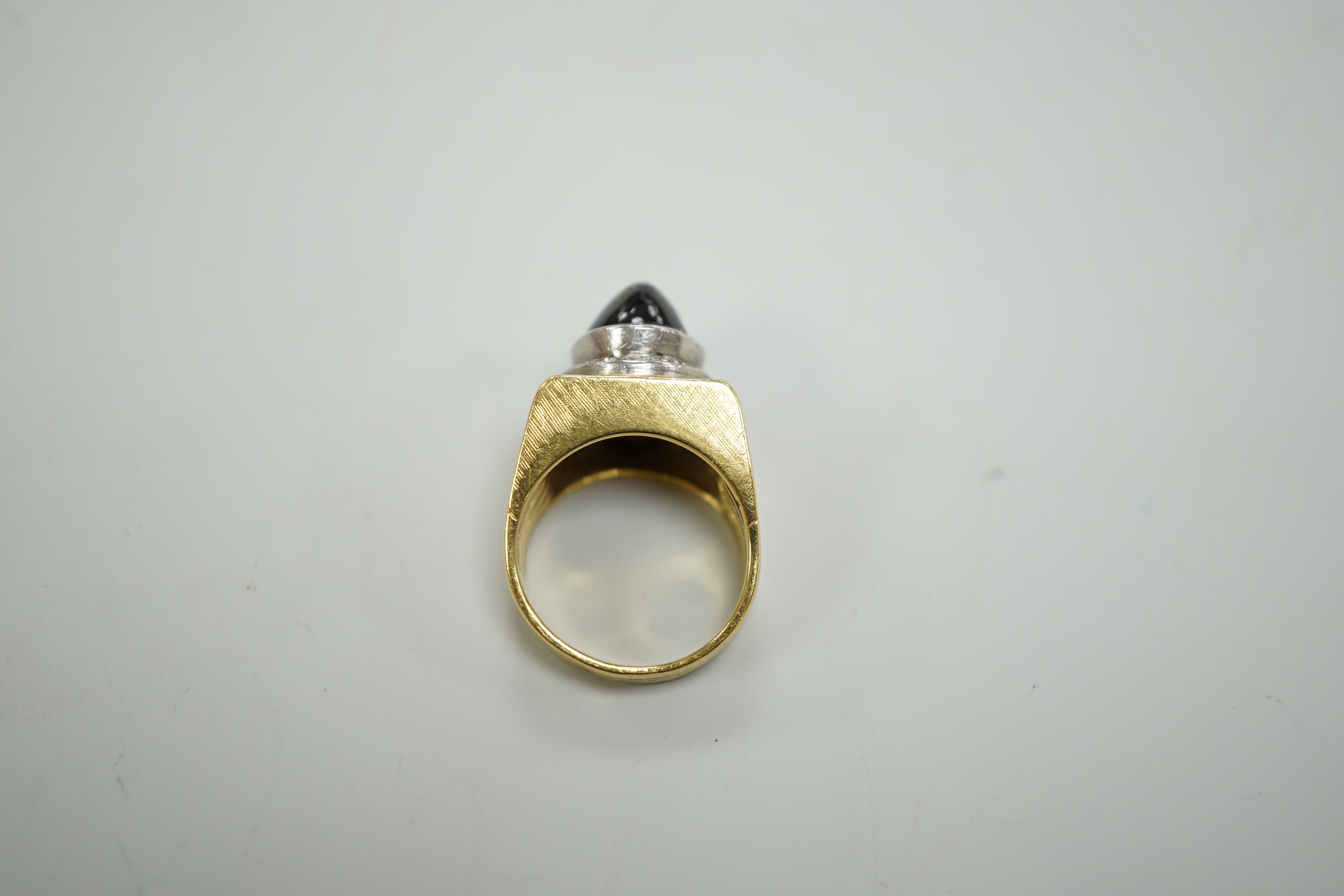 A pierced yellow metal, cabochon sapphire and diamond chip cluster set dress ring, size M, gross weight 13.4 grams.